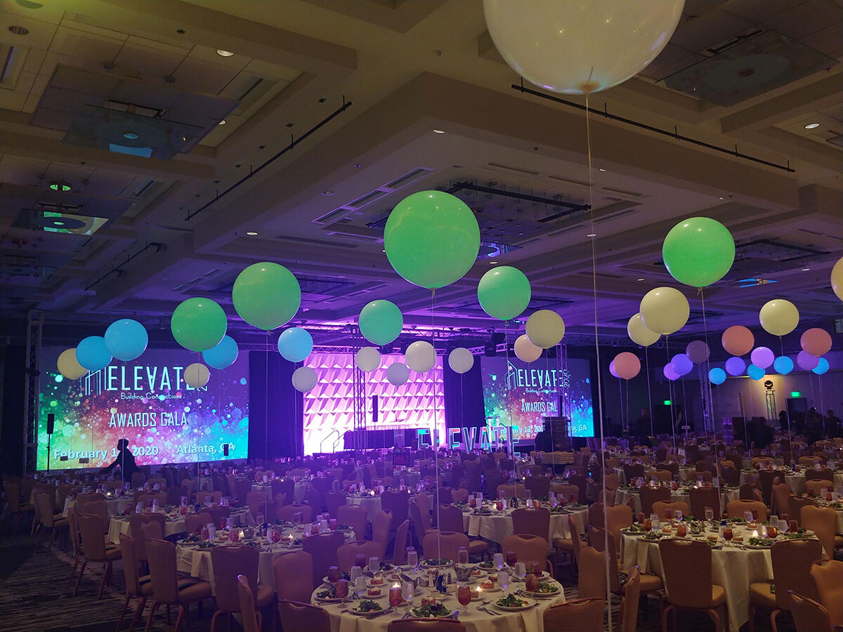 Ballroom set for the Elevate Building Connections Awards Gala 2020 with LED screens and decorative balloons