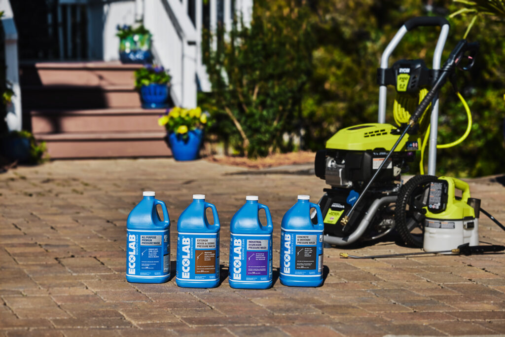 Four ecolab bottles together and a pressure washer machine.