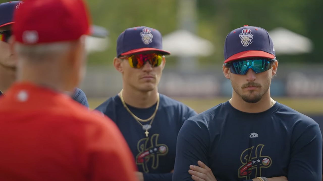 A male baseball player with his teammates around him for a Washington Nationals documentary.