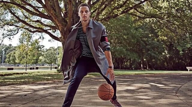 Stephen Curry playing with a basket ball in a park for a sports reel.