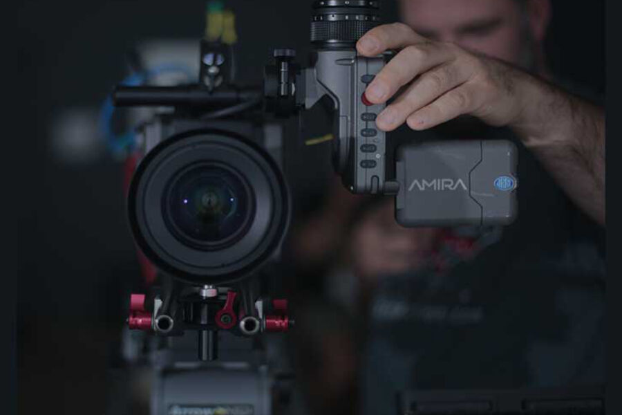 Camera operator filming with cinema camera, event videography