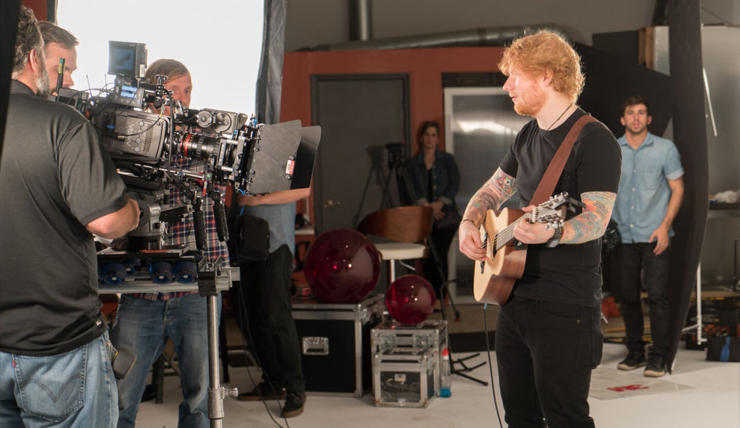 Ed Sheeran playing guitar during video production shoot with K2 Productions film crew