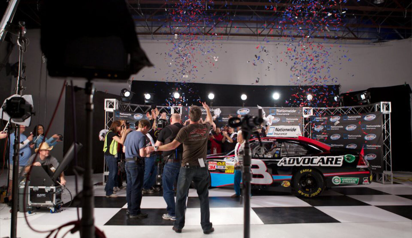 NASCAR commercial production in studio with confetti, full crew, and Nationwide branding