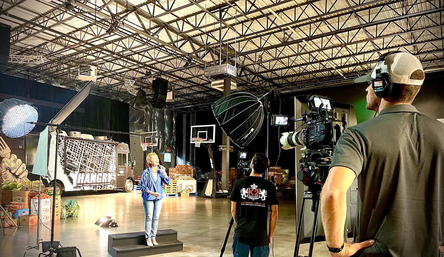 K2 Productions crew filming commercial in large studio with food truck set and presenter
