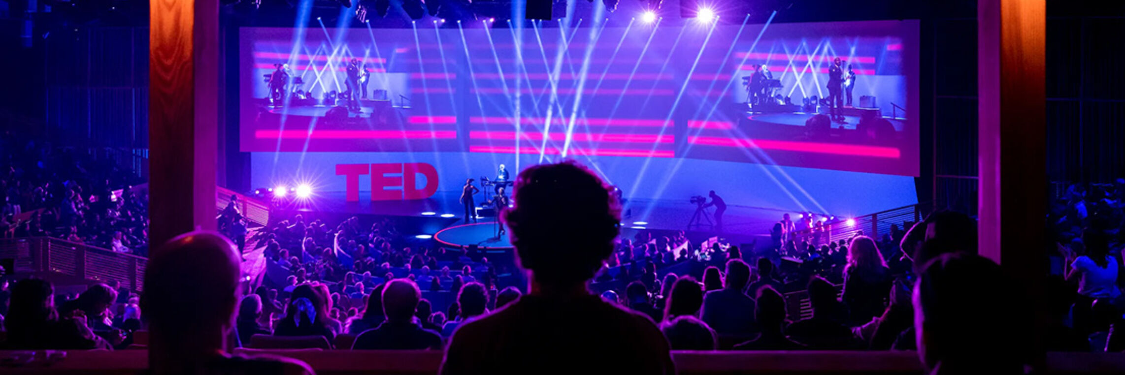 TED Talk special event production with stage lighting and large audience