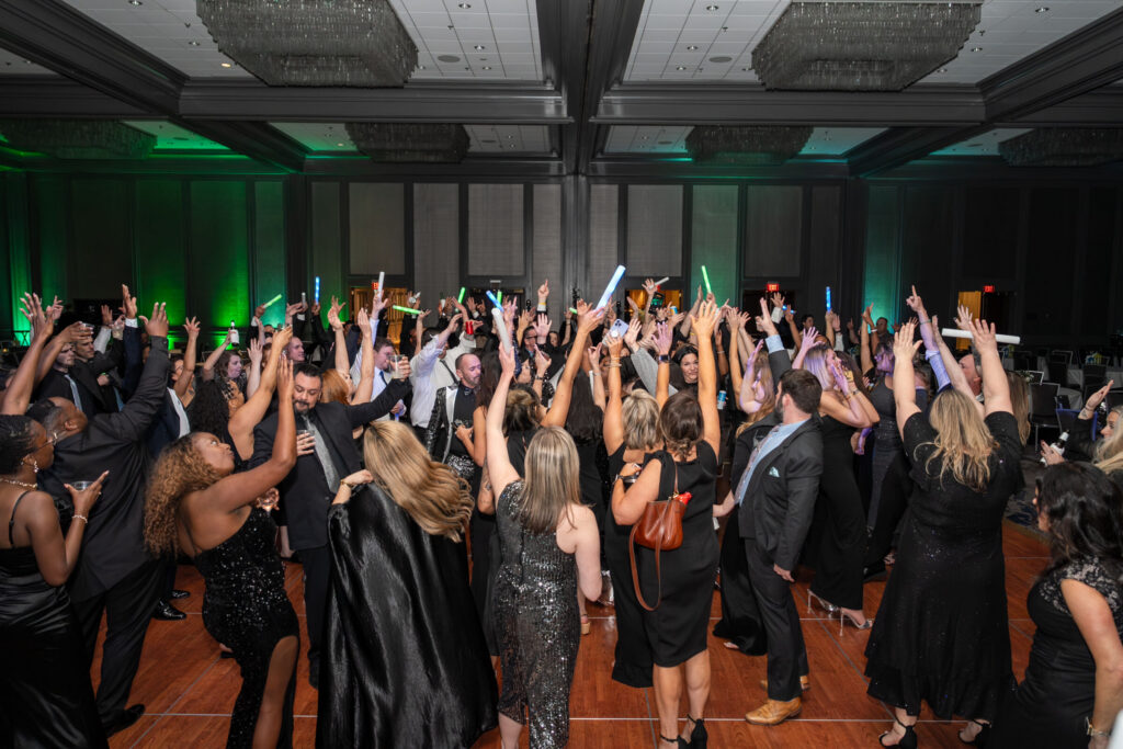 Guests dancing and celebrating with hands raised at the SOAR Hawthorne Leadership Conference evening gala