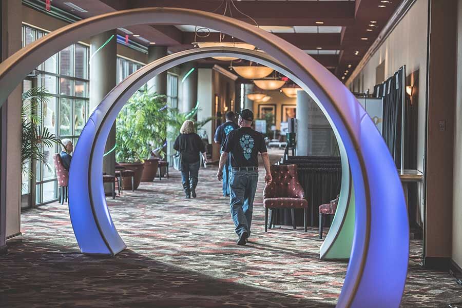 Illuminated event decor archway installed in a hotel corridor for a corporate conference, K2 Productions event design