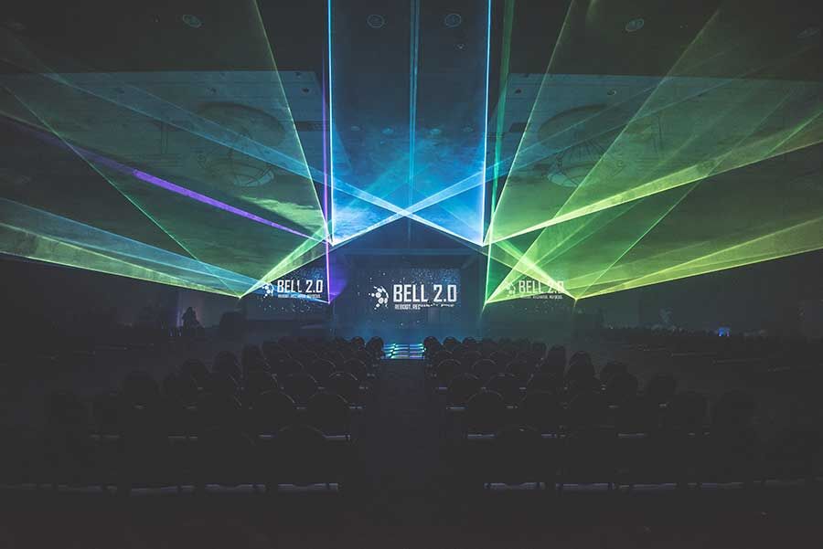 Dramatic laser light show with colorful beams over an audience at the Bell 2.0 conference, K2 Productions event lighting design