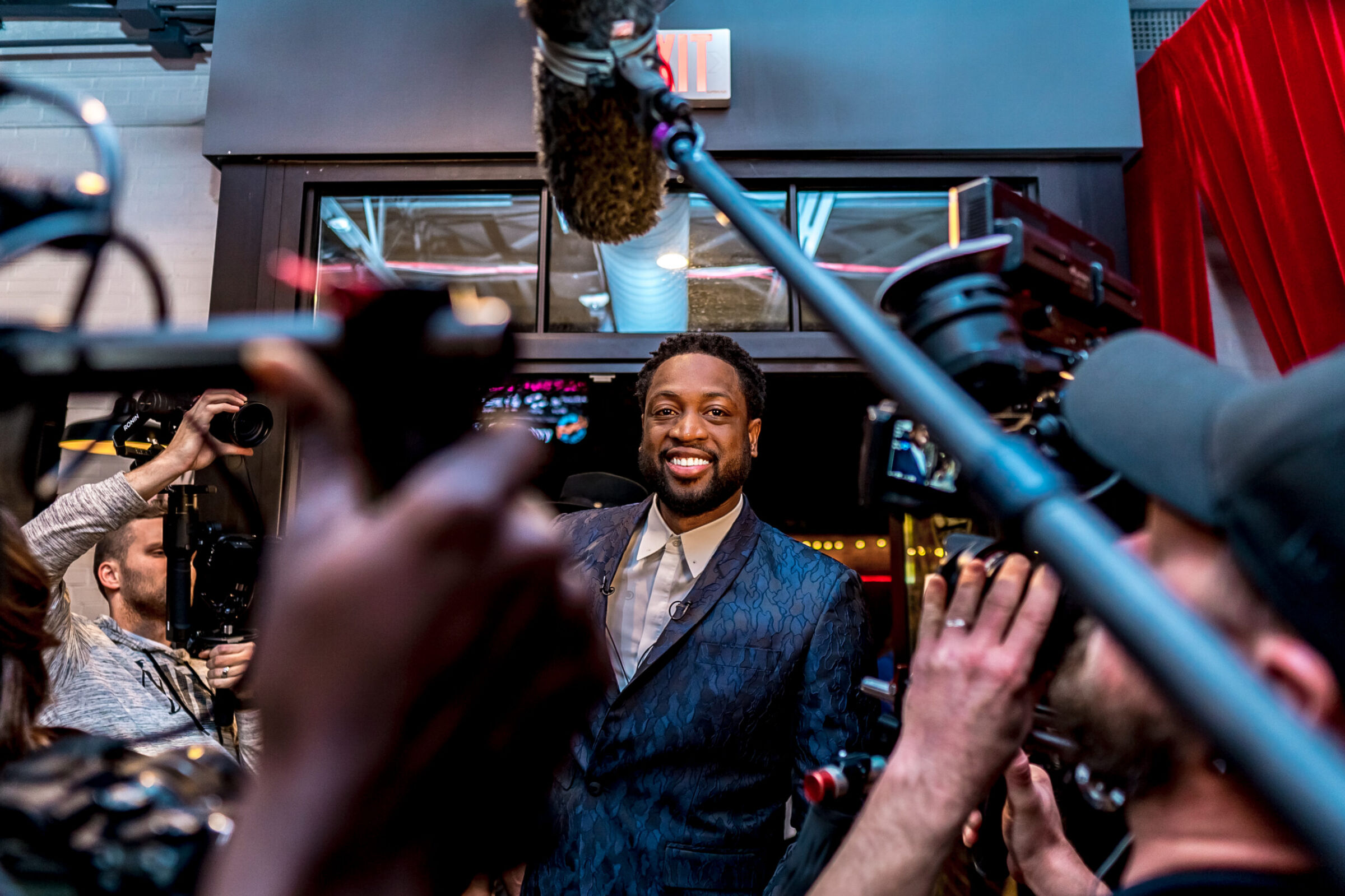 Celebrity surrounded by video cameras and microphones at the Charlotte NBA event, K2 Productions event videography